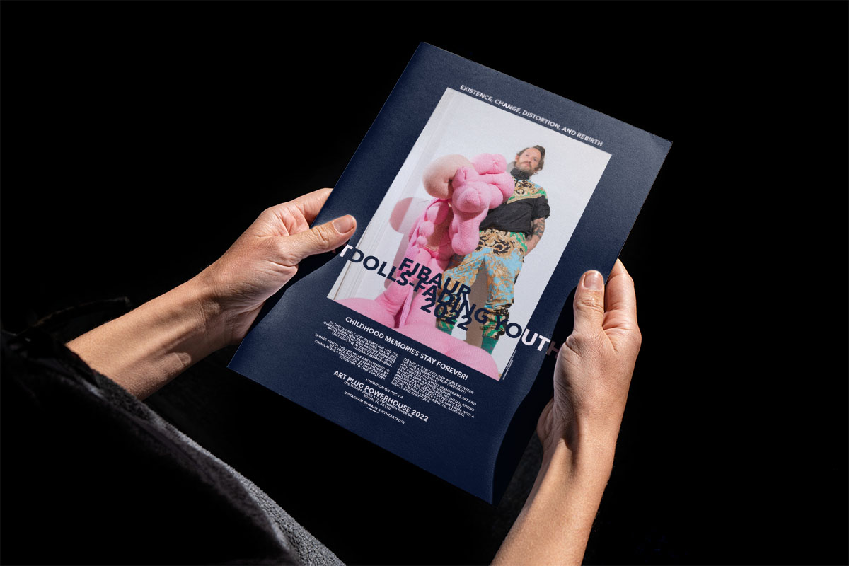 hands holding a magazine showing  an elegant full page ad for FJBAURs Art Week Miami eihibition