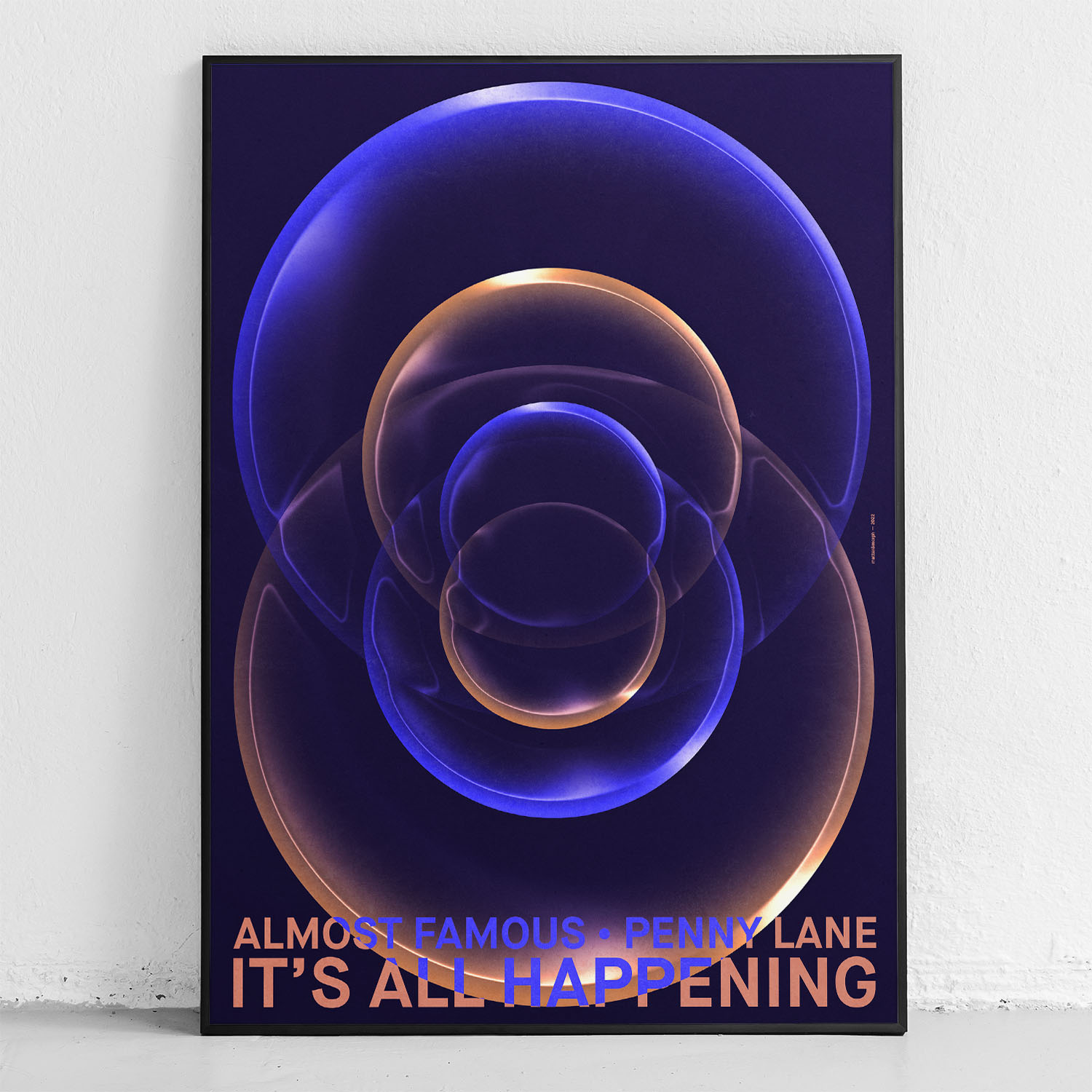 framed poster "its all happening" in front of wall